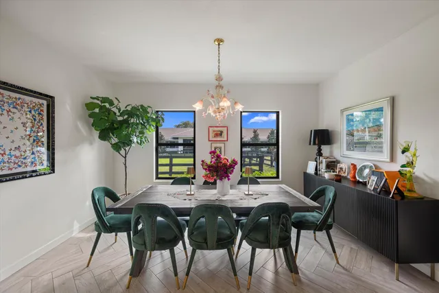 a living room with fireplace furniture a chandelier and a flat screen tv