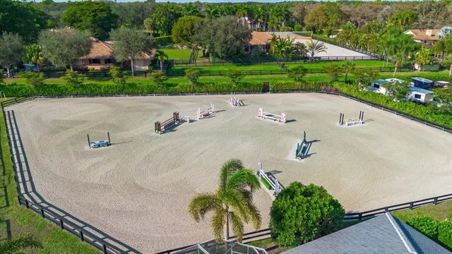an aerial view of a house with a yard and lake view
