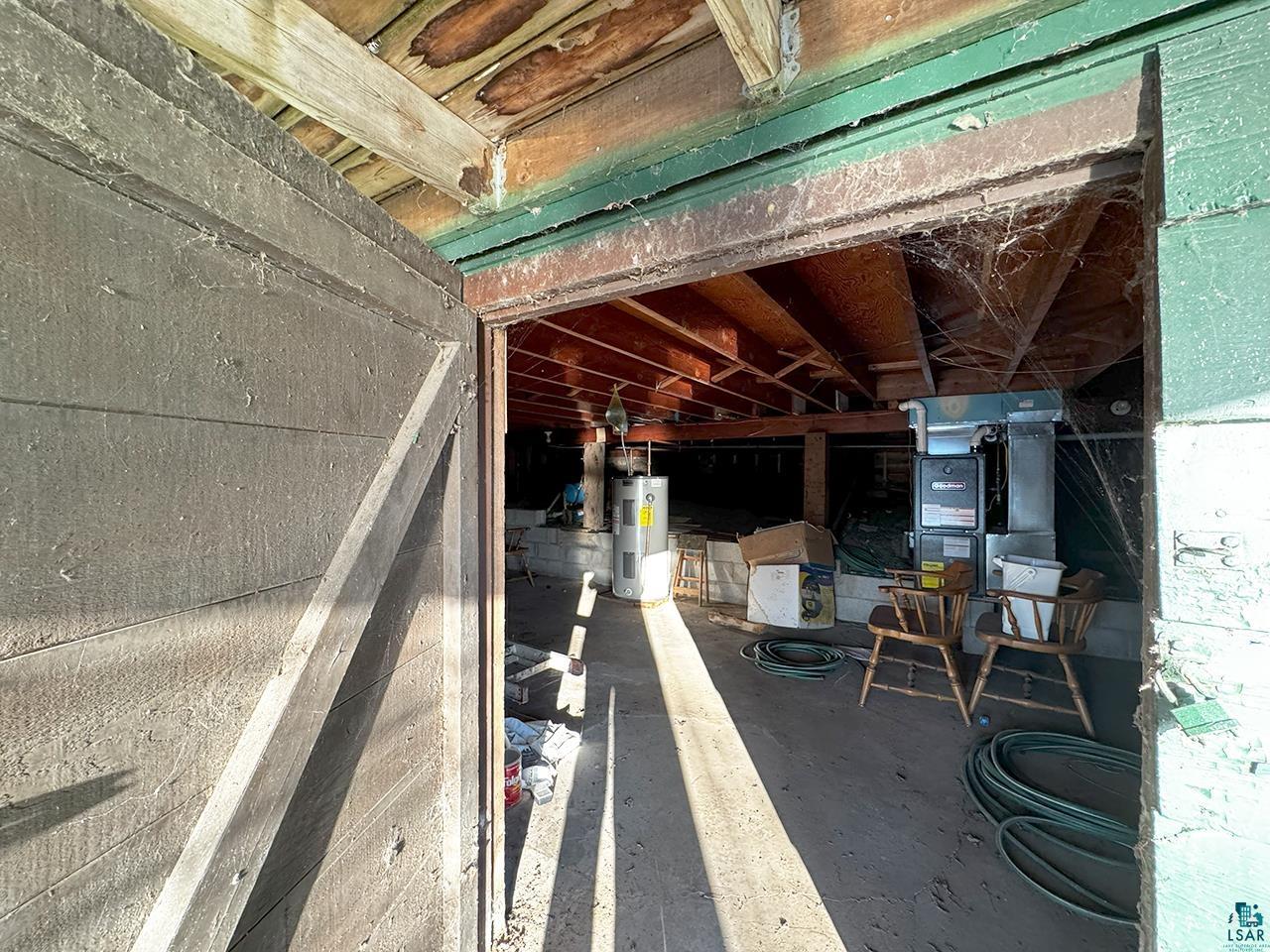 6565 White Pine Lane Gilbert, MN 55741 - Photo 14 of 25 Miscellaneous room with electric water heater, heating unit, and concrete floors