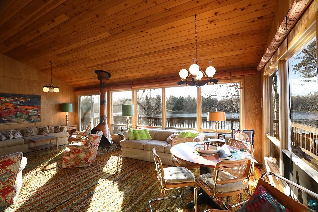 6565 White Pine Lane Gilbert, MN 55741 - Photo 3 of 25 Sunroom featuring a water view, a chandelier, healthy amount of natural light, vaulted ceiling, and wood ceiling