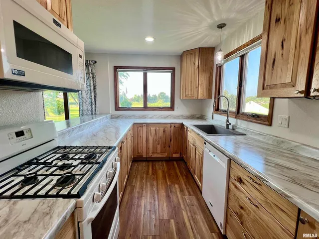 a kitchen with a sink window and cabinets