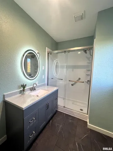 a view of room with wooden floor and fan