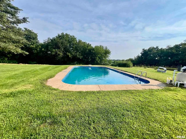 a aerial view of a house with swimming pool and garden