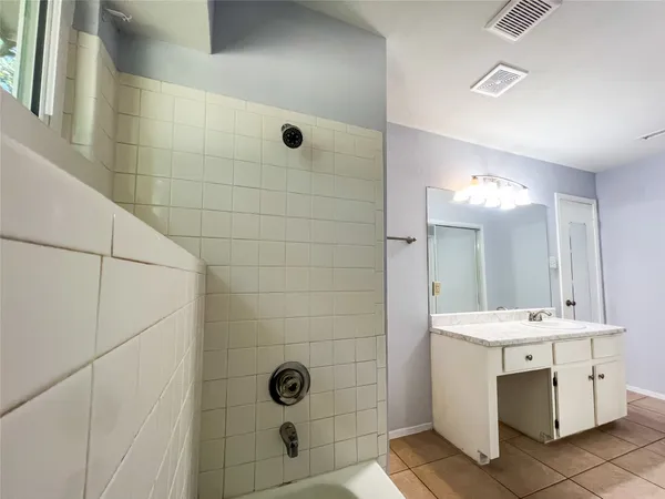 a bathroom with a double vanity sink mirror and shower