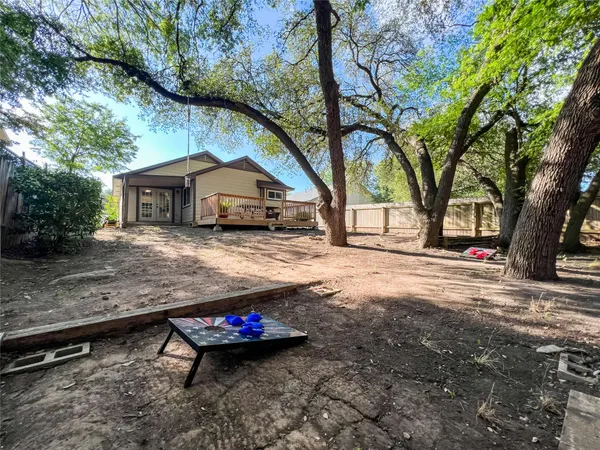a wooden bench sitting in middle of a yard