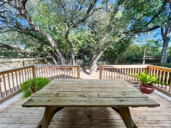 a view of a wooden deck with chairs