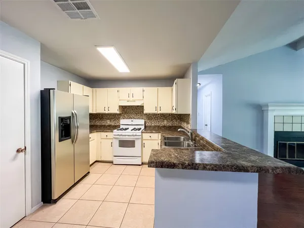 a kitchen with a refrigerator sink and stove