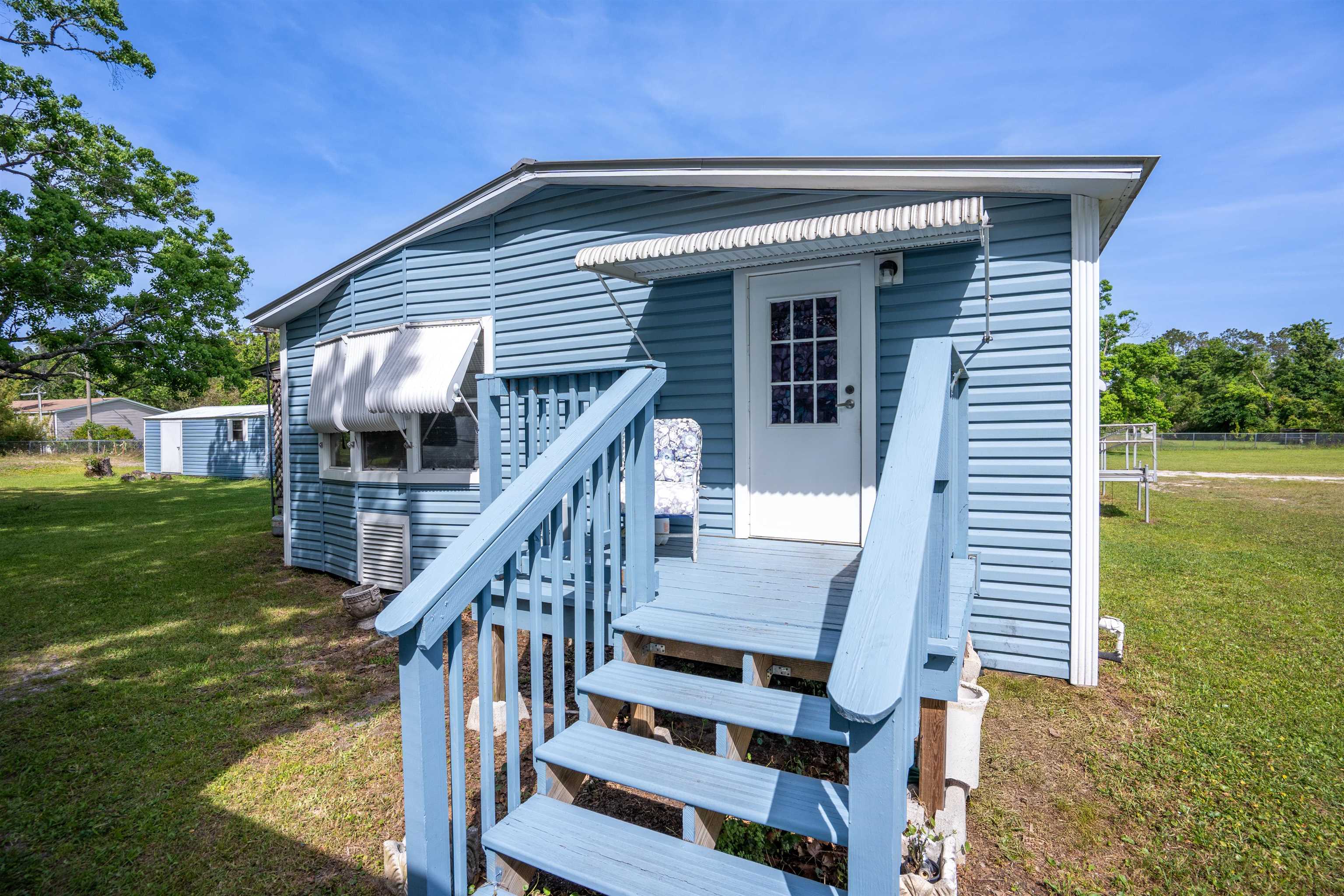 3140 Raulerson Road East St. Augustine, FL 32092 - Photo 7 of 23 a front view of house with deck and yard