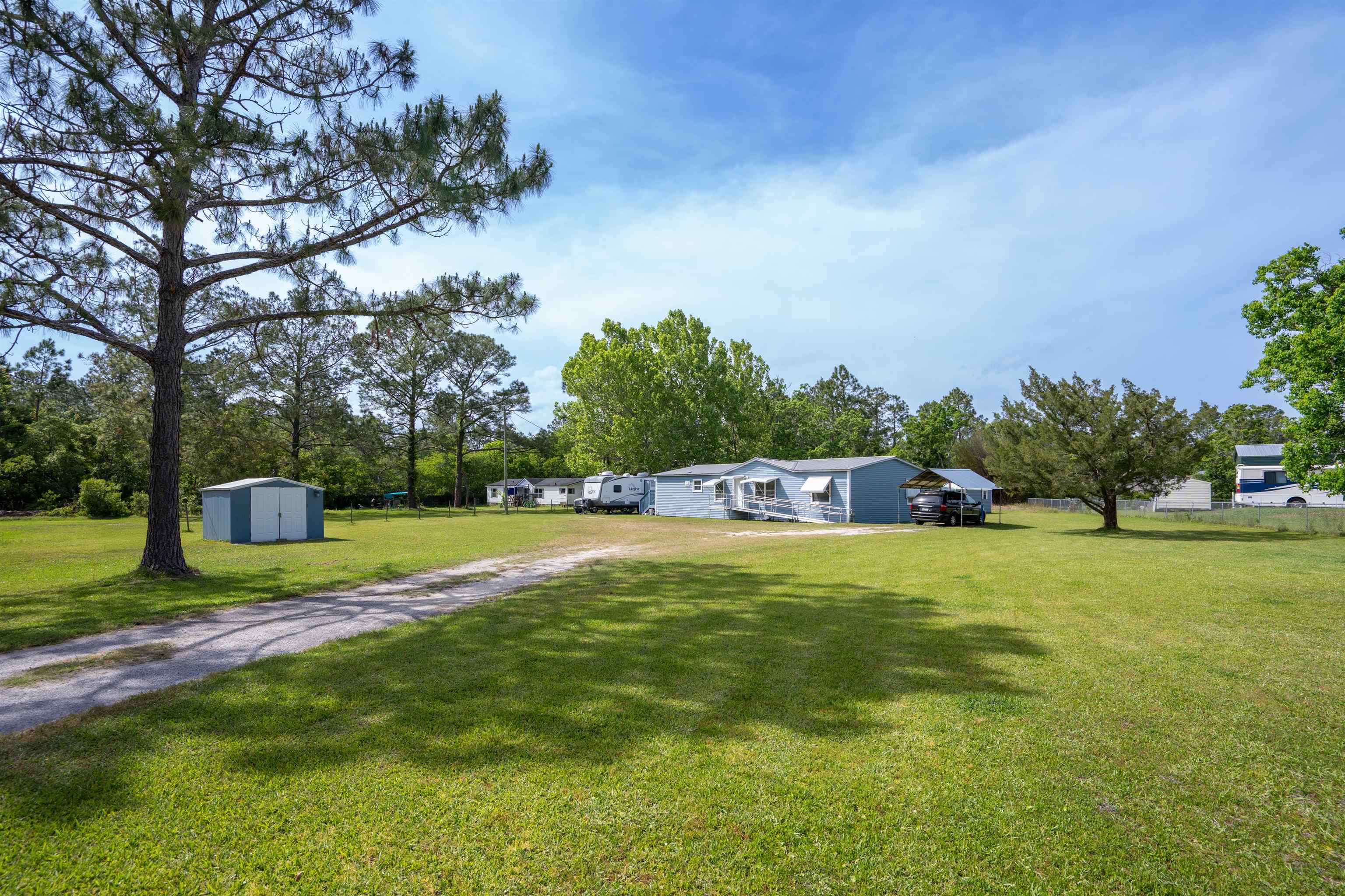 3140 Raulerson Road East St. Augustine, FL 32092 - Photo 9 of 23 a backyard of a house with table and chairs