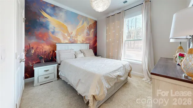 a spacious bedroom with a bed and a window