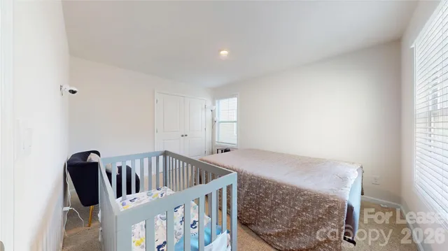 a bedroom with a bed couch and window