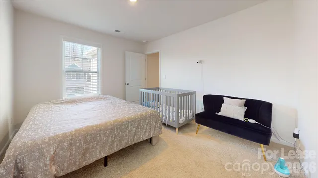 a bedroom with a bed and a chair