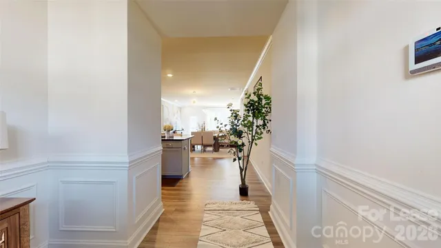 a hallway with a dining table and chairs