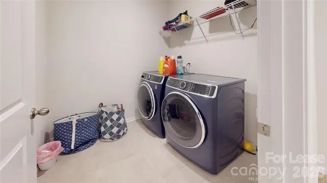 a room with gym equipment and lots of potted plants