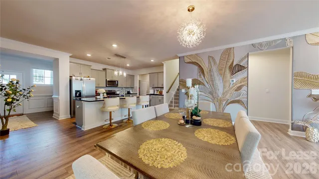 a kitchen with stainless steel appliances granite countertop a sink refrigerator and cabinets