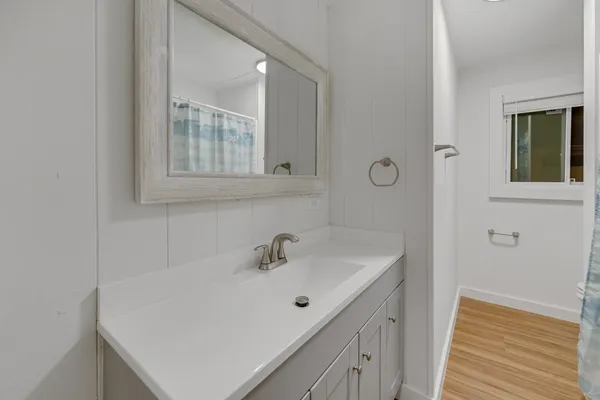 a bathroom with a sink and a mirror