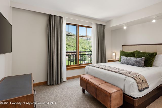 a spacious bedroom with a bed and a couch