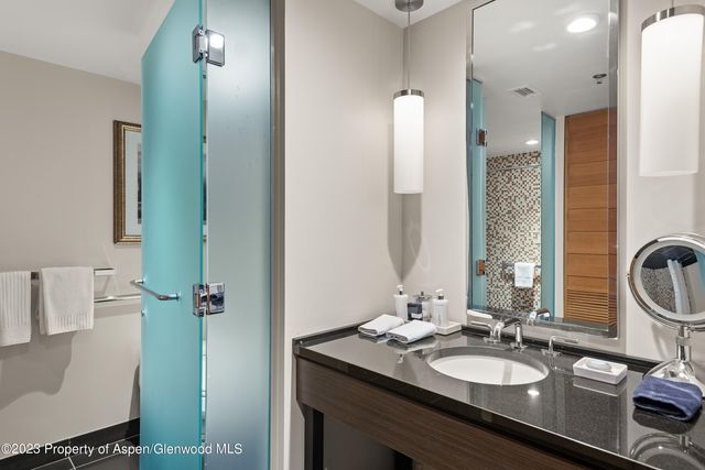 a view of a patio with table and chairs under an umbrella