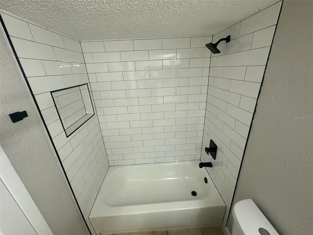 a bathroom with a bathtub and toilet