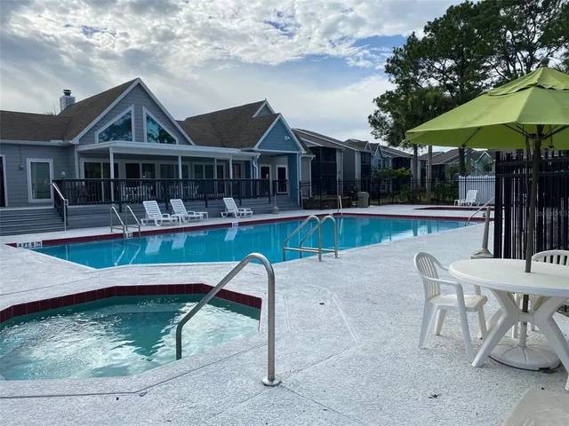 a view of a house with swimming pool and sitting area