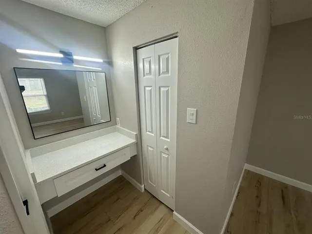 a bathroom with a sink a mirror and a shower