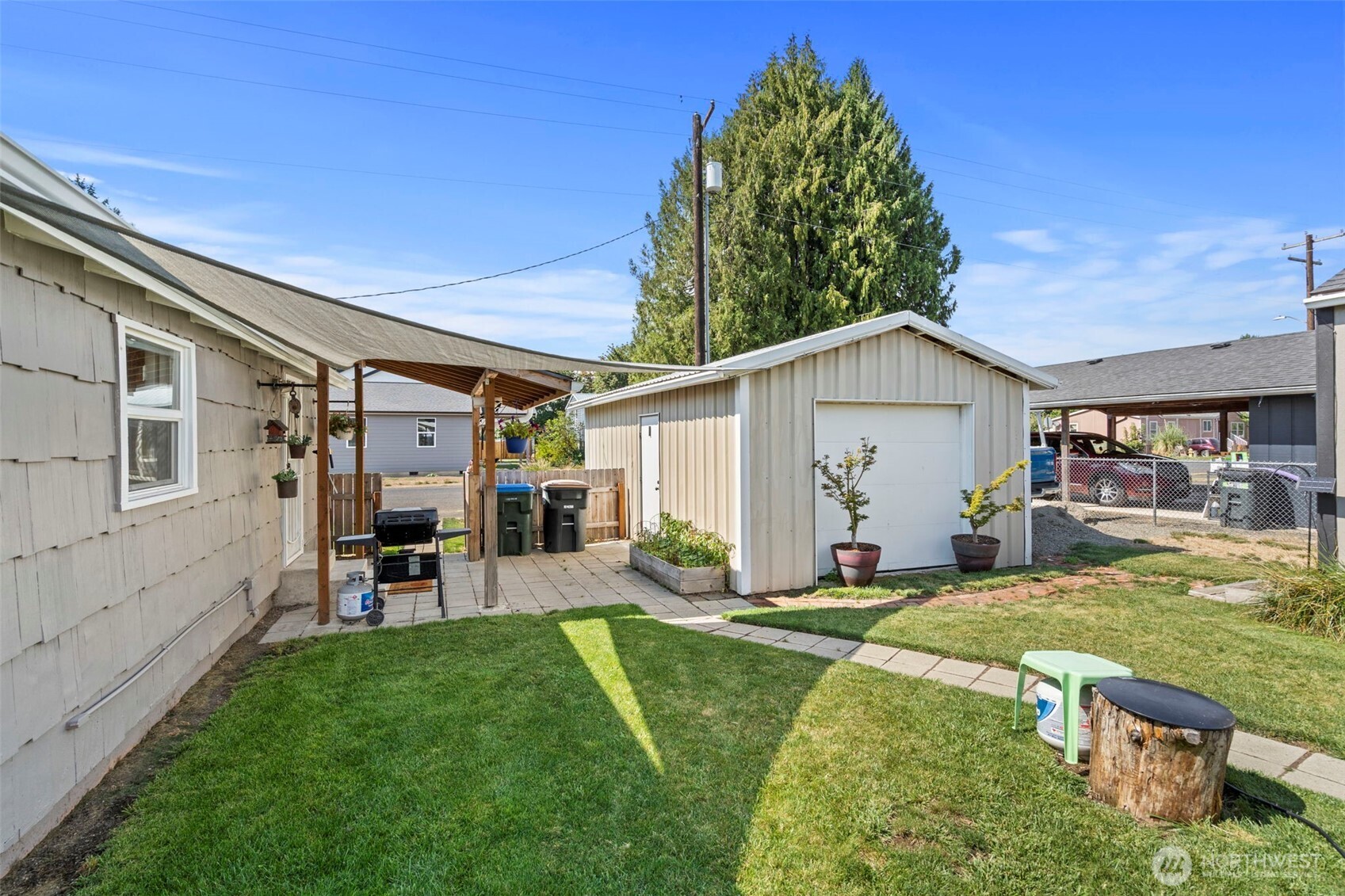 450 Cedar Street Toledo, WA 98591 - Photo 14 of 38 a view of a backyard with table and chairs and a barbeque