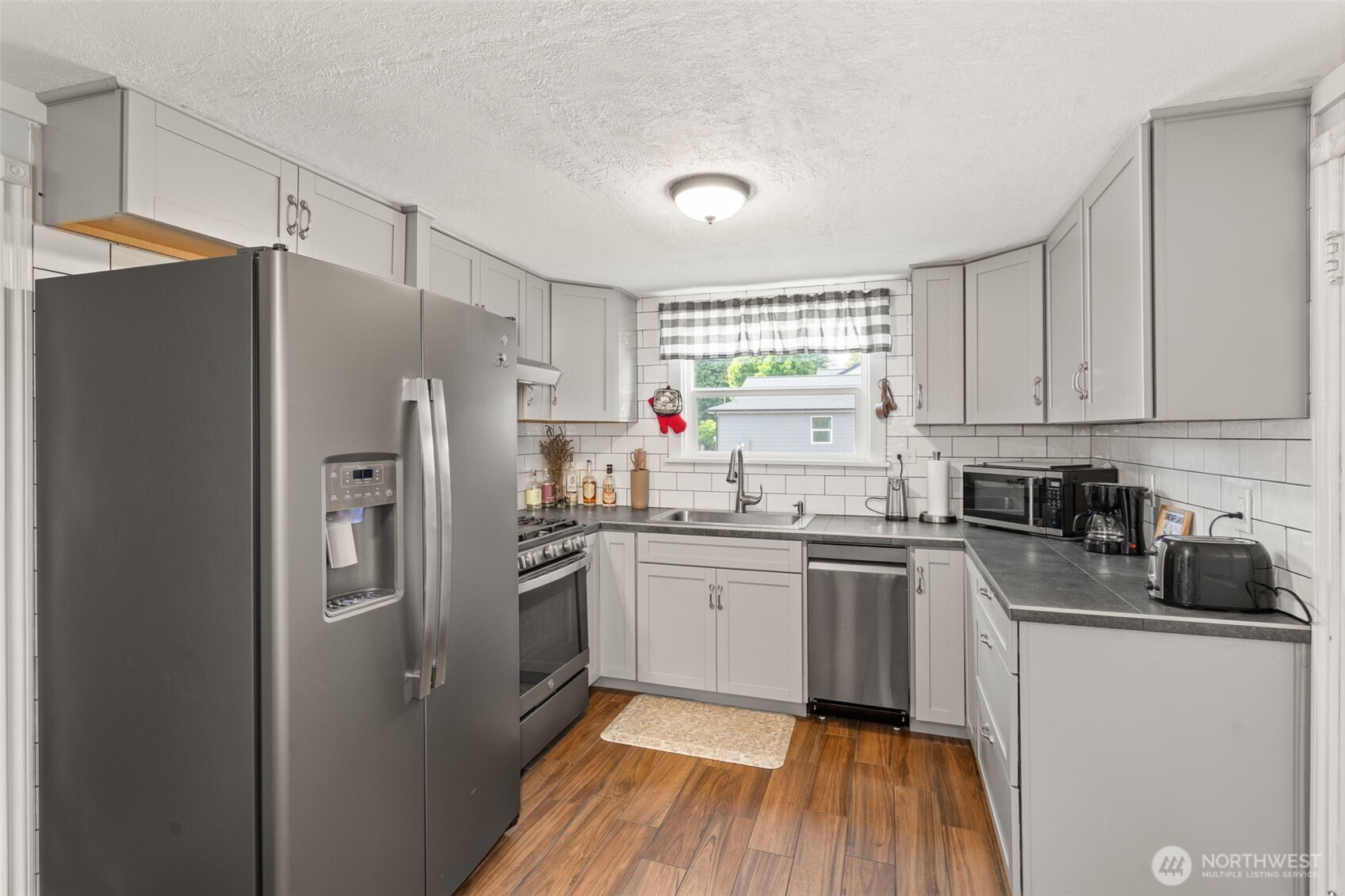 450 Cedar Street Toledo, WA 98591 - Photo 33 of 38 a kitchen with stainless steel appliances a refrigerator sink and microwave