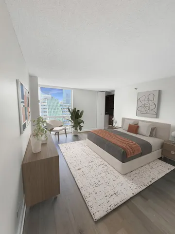 a spacious bedroom with a bed and dresser with mirror