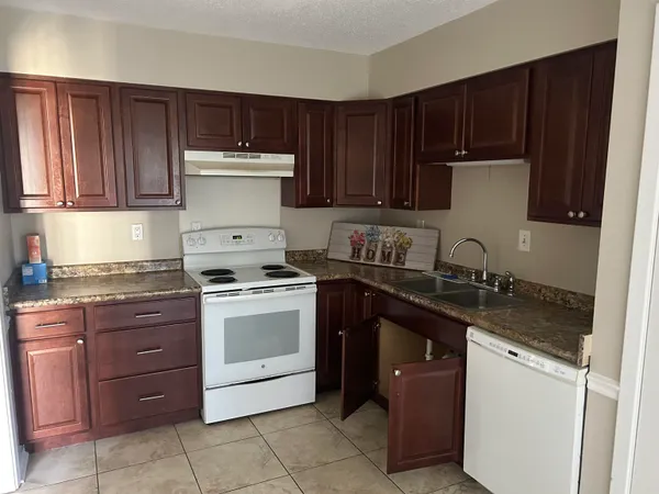 a kitchen with a sink and a stove top oven