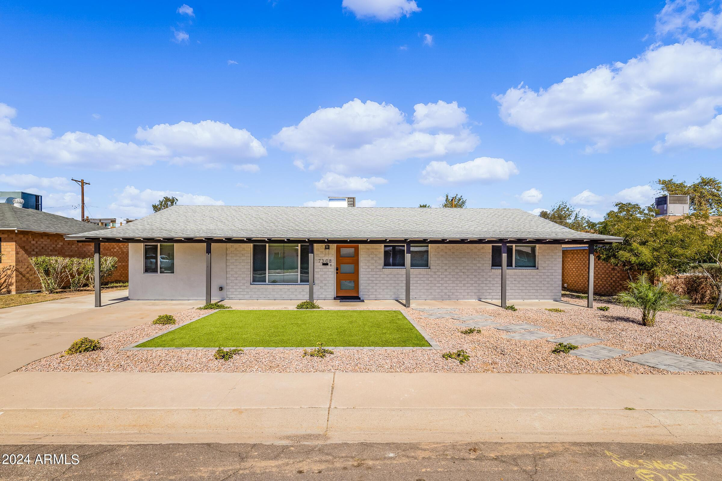 7308 East Granada Road Scottsdale, AZ 85257 - Photo 1 of 39 a front view of a house with a yard