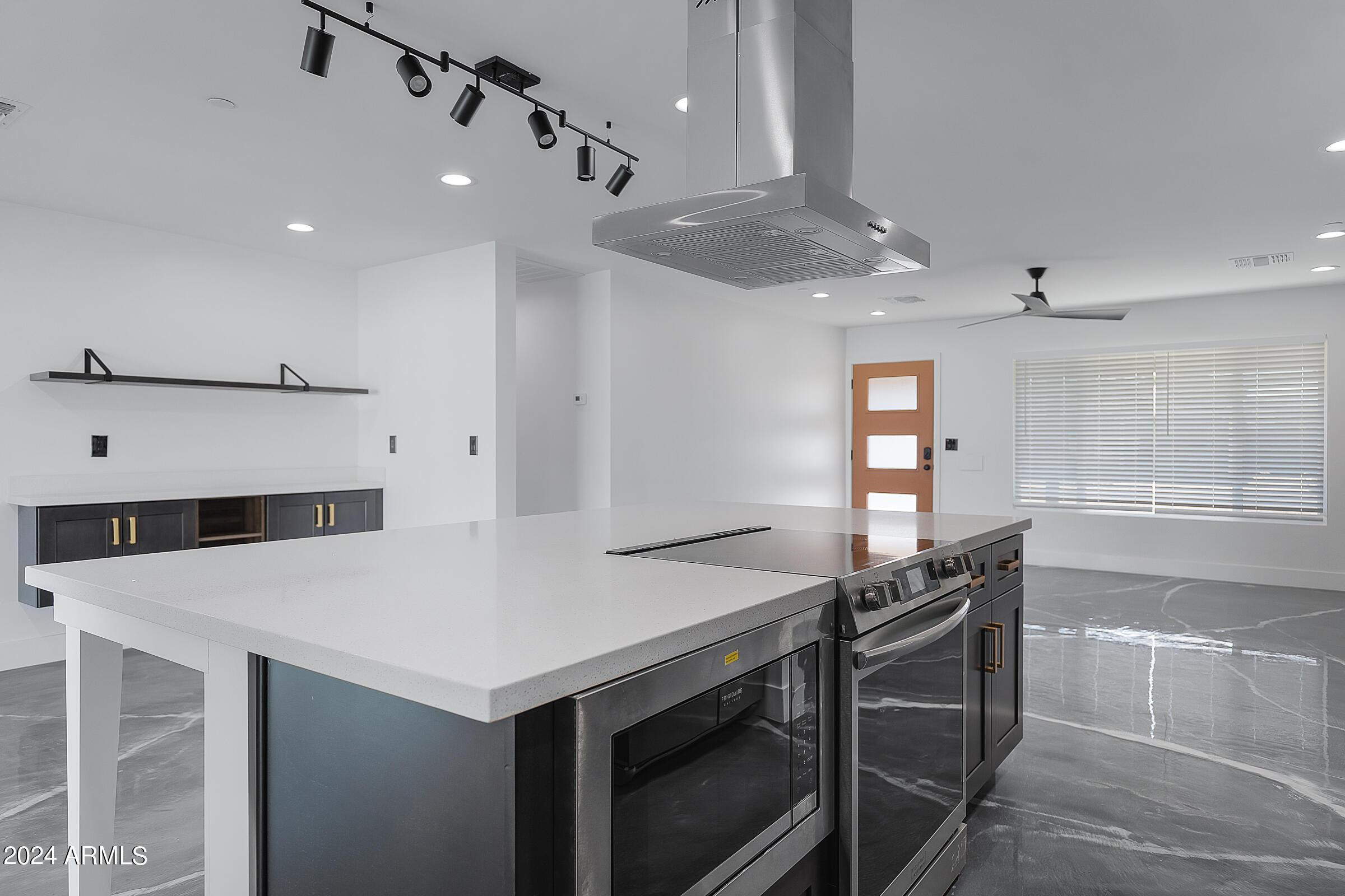 7308 East Granada Road Scottsdale, AZ 85257 - Photo 11 of 39 a kitchen with stainless steel appliances a table and chairs
