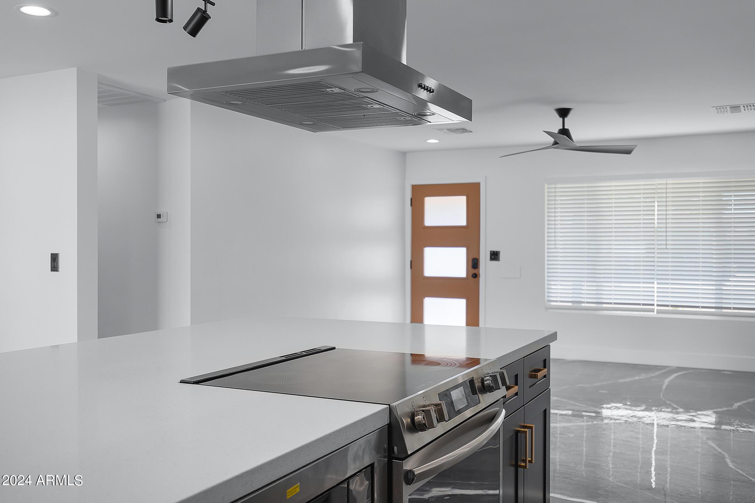 7308 East Granada Road Scottsdale, AZ 85257 - Photo 12 of 39 a kitchen with a stove a sink and a window