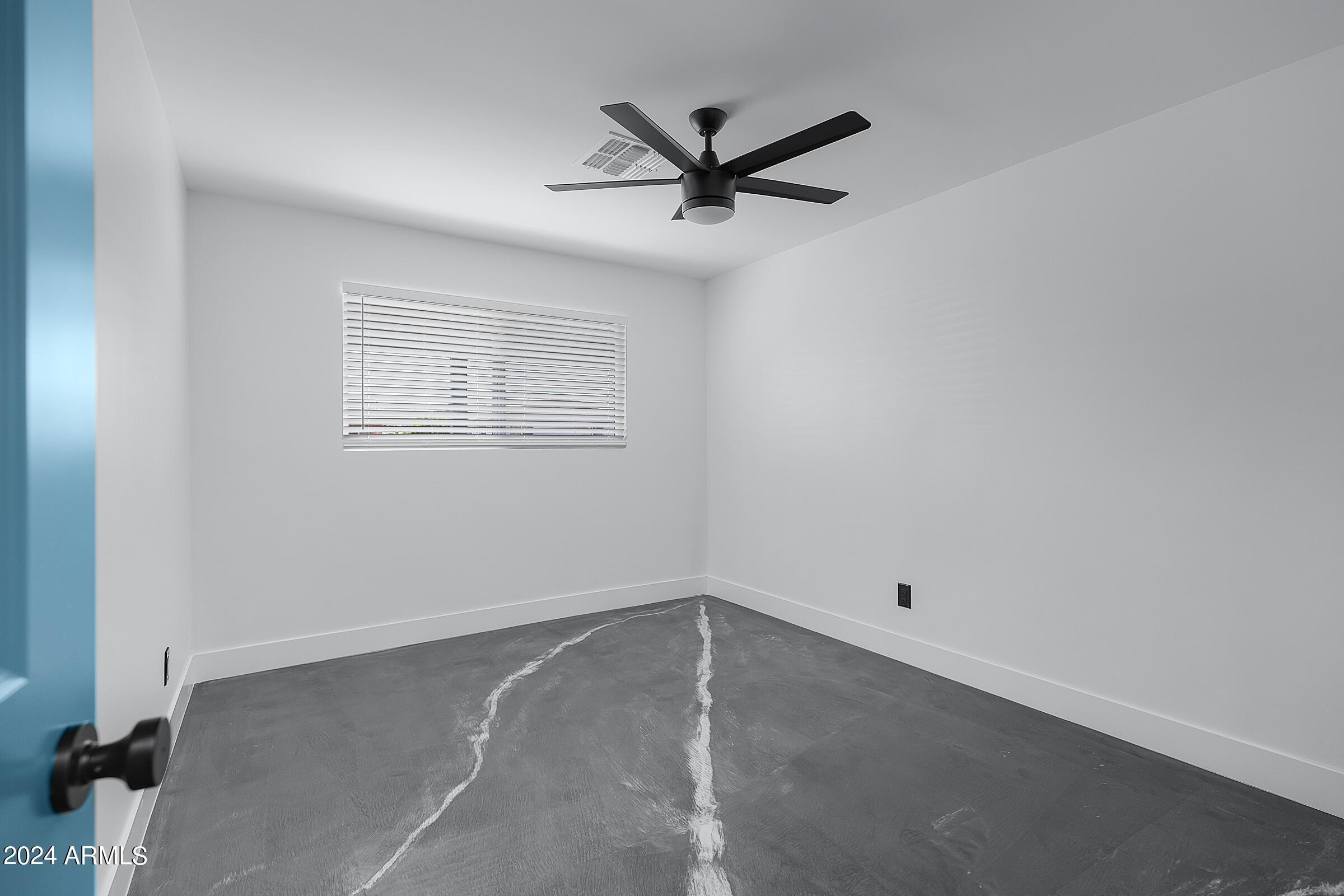 7308 East Granada Road Scottsdale, AZ 85257 - Photo 29 of 39 an empty room with a window and a fan