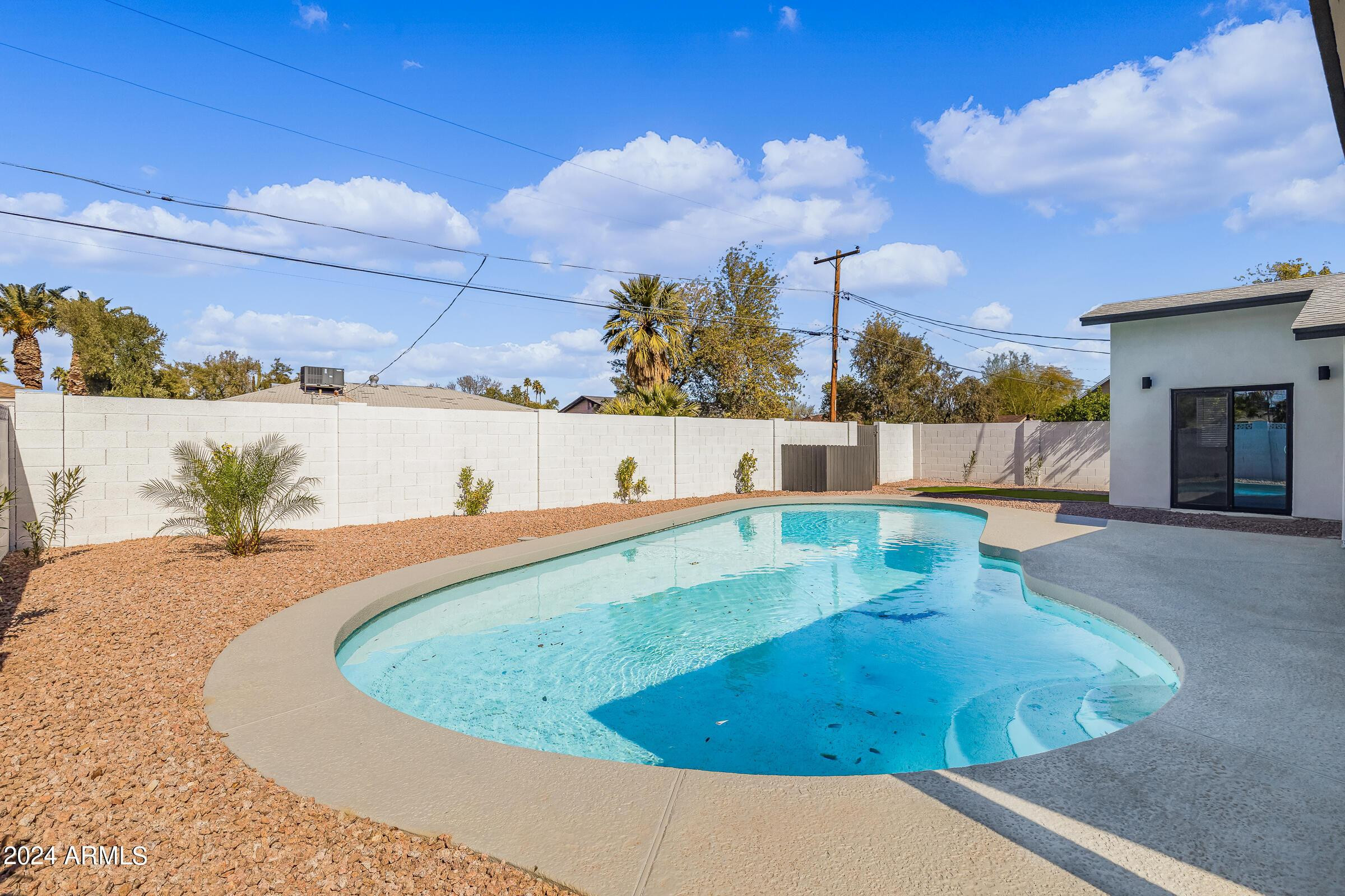 7308 East Granada Road Scottsdale, AZ 85257 - Photo 35 of 39 a view of a swimming pool with a yard