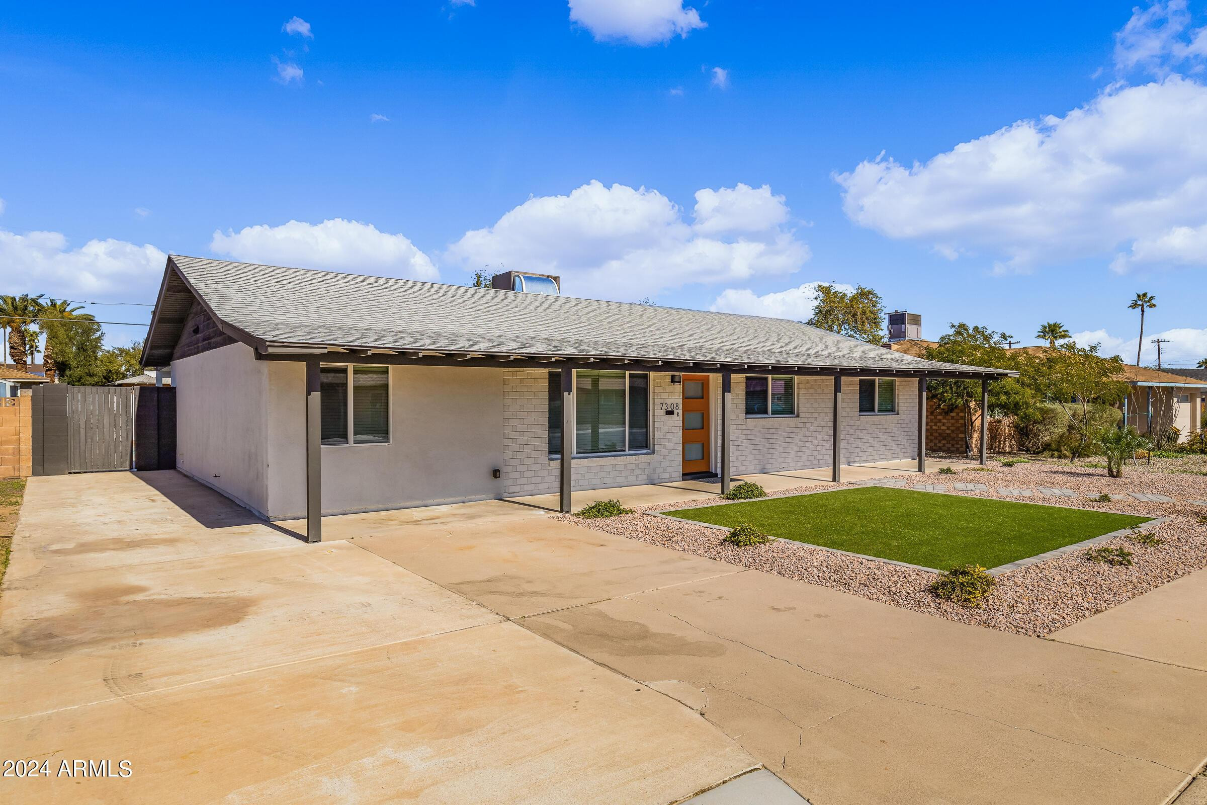 7308 East Granada Road Scottsdale, AZ 85257 - Photo 37 of 39 a front view of a house with a yard and garage