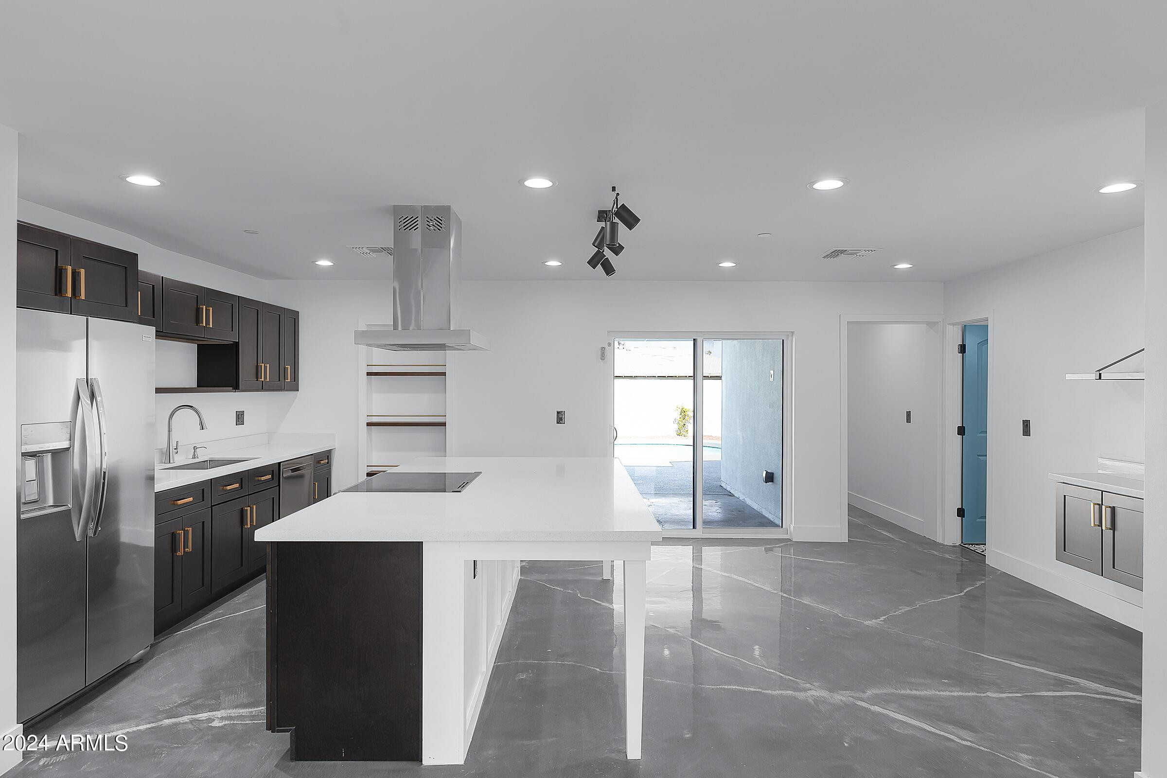 7308 East Granada Road Scottsdale, AZ 85257 - Photo 8 of 39 a kitchen with refrigerator and cabinets
