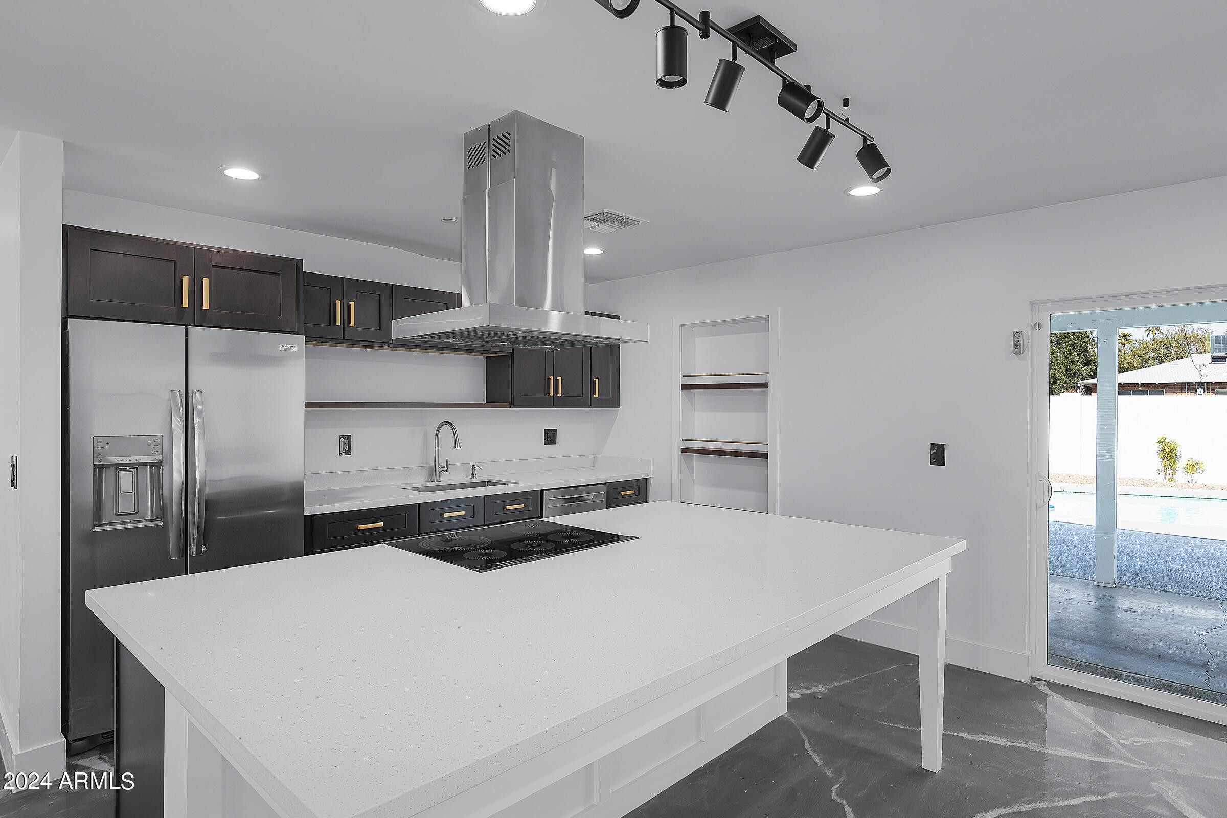 7308 East Granada Road Scottsdale, AZ 85257 - Photo 9 of 39 a kitchen with stainless steel appliances a sink a table and chairs