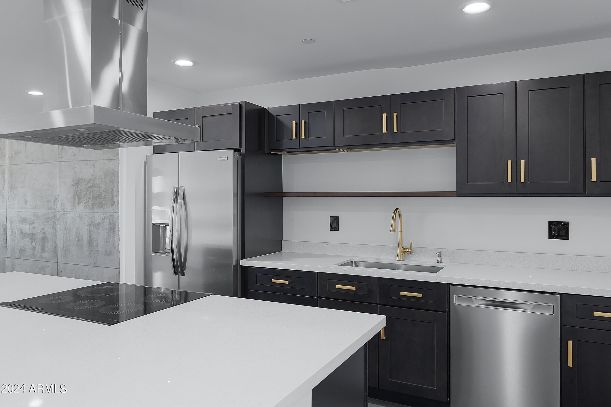 7308 East Granada Road Scottsdale, AZ 85257 - Photo 10 of 39 a kitchen with a sink a refrigerator and cabinets