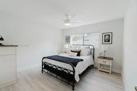 a bedroom with a bed and a night stand