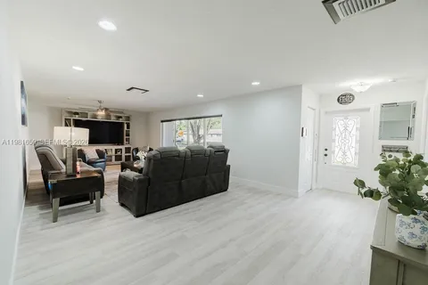 a living room with furniture flat screen tv and a fireplace