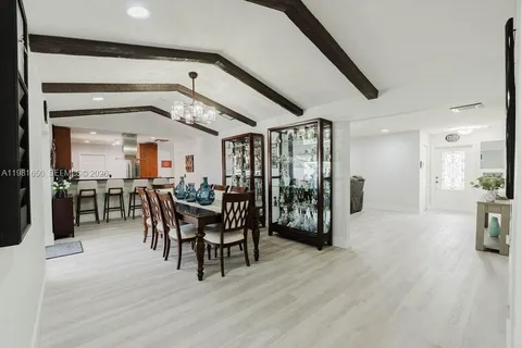 a dining room with furniture and wooden floor