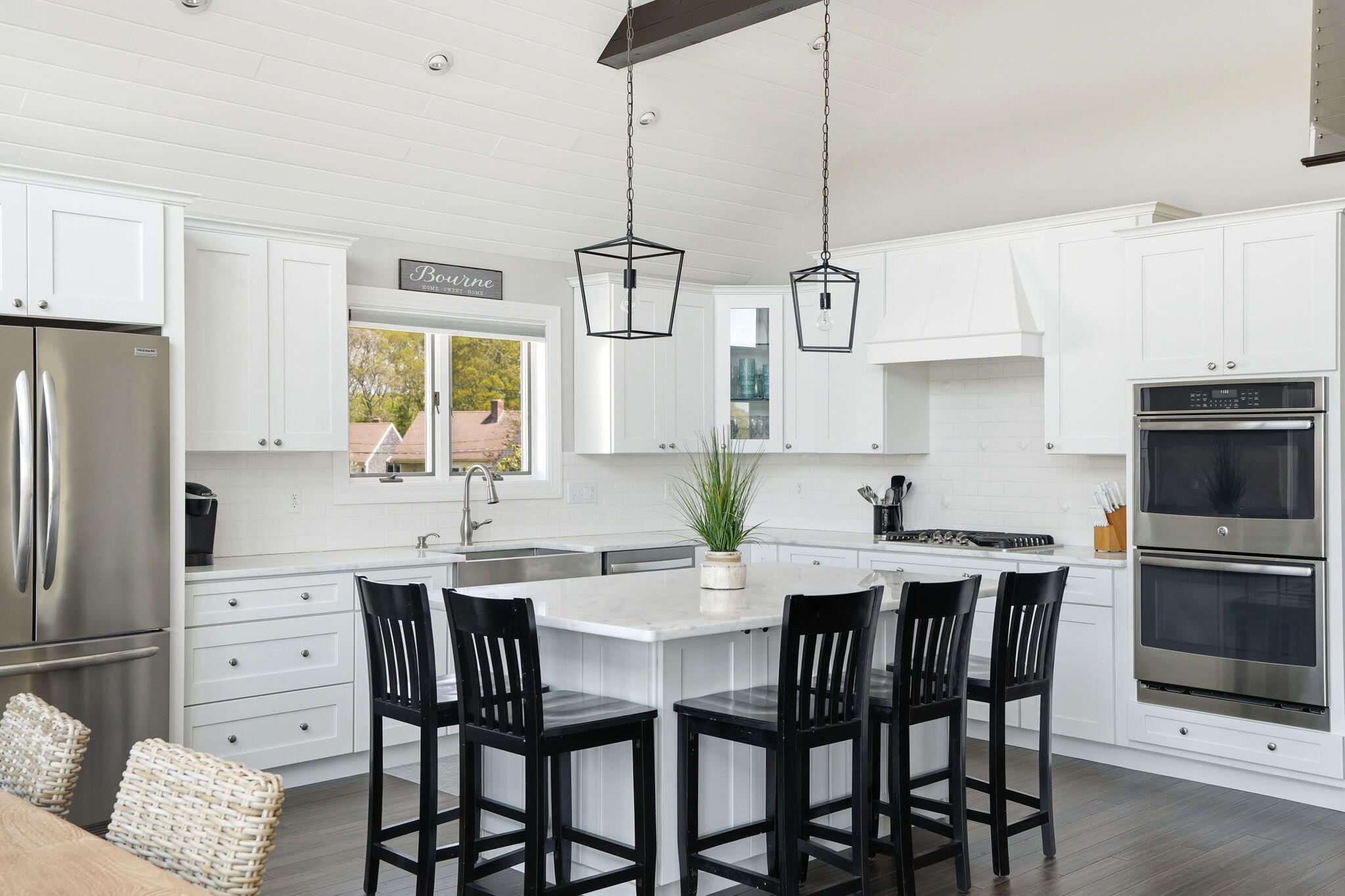 4 Cross Road Bourne, MA 02532 - Photo 10 of 47 a kitchen with stainless steel appliances a dining table chairs stove refrigerator and cabinets