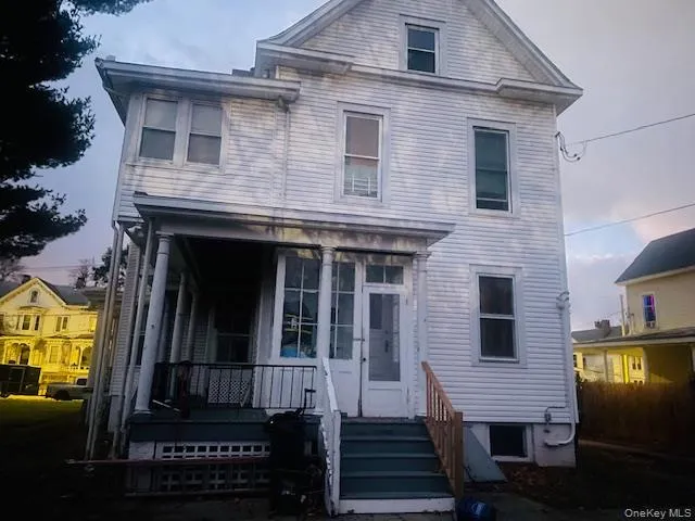 a view of a house with a door and wooden floor