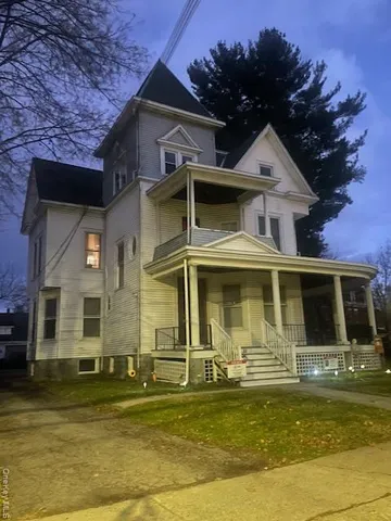 a front view of a house with a garden
