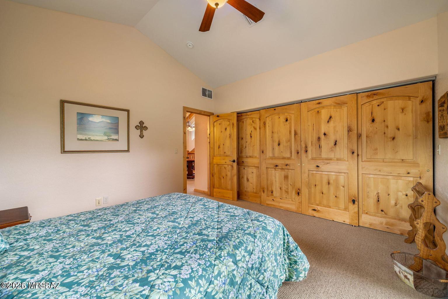17 2195 Alpine, AZ 85920 - Photo 18 of 48 a bedroom with a large bed and a chandelier fan