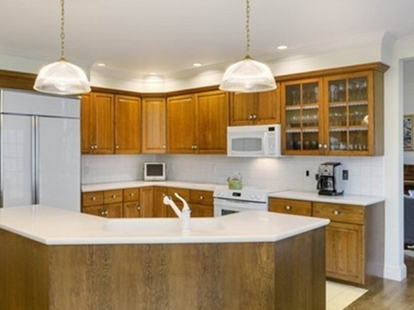 3 Turnburry Hill Road, Unit 3 Lexington, MA 02421 - Photo 7 of 14 a kitchen with stainless steel appliances granite countertop a sink a stove and a refrigerator
