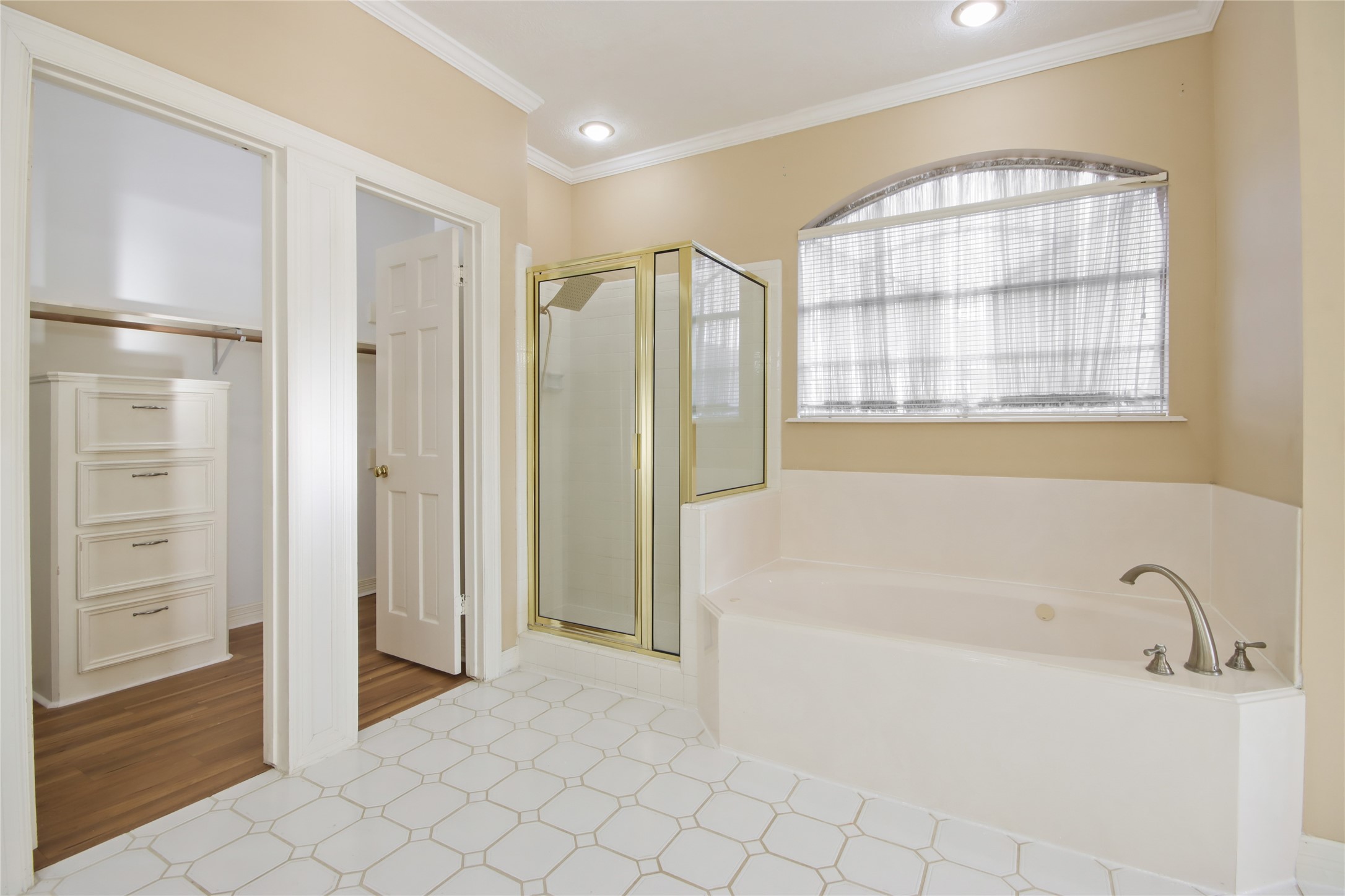 8411 Rockford Hall Drive Spring, TX 77379 - Photo 15 of 32 A luxurious primary bath retreat featuring a separate soaking tub and walk-in shower, creating a spa-like environment designed for relaxation and renewal.
