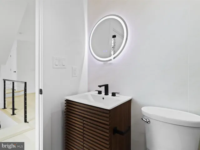 a bathroom with a toilet a sink and shower