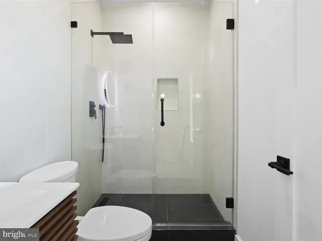 a bathroom with a sink a toilet and a mirror