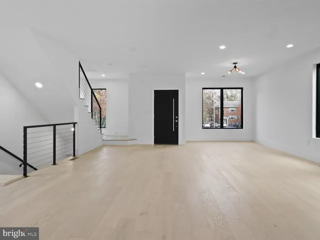 a bedroom with a bed and large window